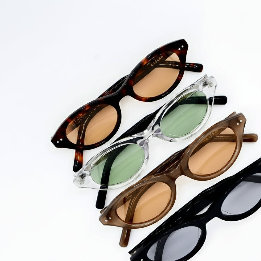 Four pairs of sunglasses with different frame colors and lens colors on a white background.